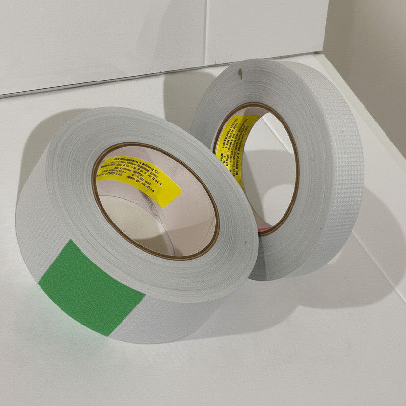E&H 753-MP two rolls angled showing yellow E&H Laminating core labels with BMS 5-157 Grade A/C specification text