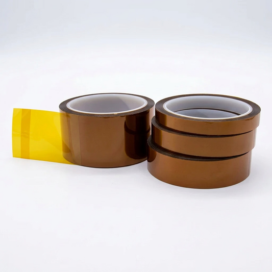 Four rolls of amber polyimide film tape, with one roll partially unwound, on a white background.